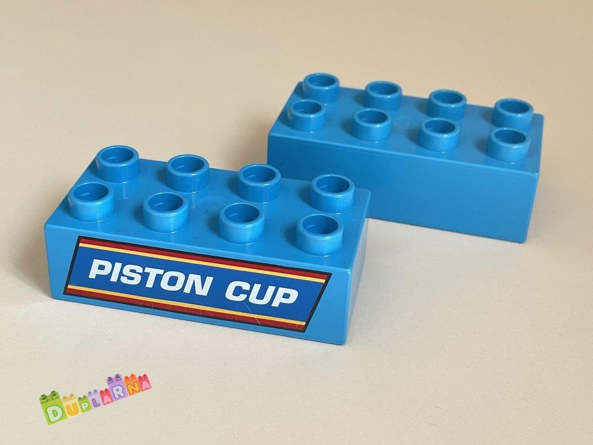 Lego Duplo - Kostka 2x4 s potiskem "Piston Cup"